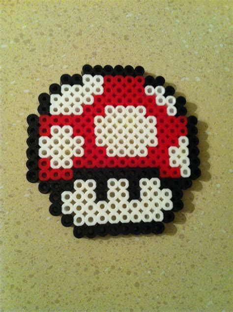 A fusion between the Holidays Spririt and the Super Mario World Perfect to give a geek side at your Christmas decoration Size 3" wide x 4" tall (8 cm x 10 cm) Also available with magnet or a hook for your tree Free shipping with a order of 45CAN or more. . Mario mushroom perler
